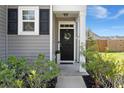 Inviting front door with gray siding, decorative wreath, and manicured landscaping at 223 Goshen Rd, Moncks Corner, SC 29461