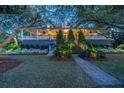 Beautiful home with a spacious porch, manicured lawn, and a charming walkway leading to the entrance at 2629 Goldbug Ave, Sullivans Island, SC 29482