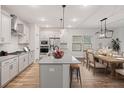 Open-concept kitchen and dining area with modern appliances, pendant lighting, a dining table, and hardwood floors at 265 Lucca Dr, Summerville, SC 29486