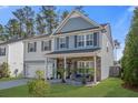 Charming two-story home with a two-car garage, covered porch, and well-manicured lawn at 301 Dunlin Dr, Summerville, SC 29486