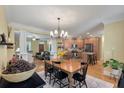 Open-concept dining area with hardwood floors, stylish lighting, and seamless flow to the kitchen at 3023 Macbeth Creek Dr, Charleston, SC 29414