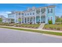 Charming townhomes boast double porches, inviting curb appeal, and classic architectural details at 3119 Sturbridge Rd, Mount Pleasant, SC 29466