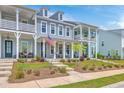 Charming townhomes boast double porches, inviting curb appeal, and classic architectural details at 3119 Sturbridge Rd, Mount Pleasant, SC 29466
