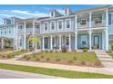 Charming townhomes boast double porches, inviting curb appeal, and classic architectural details at 3119 Sturbridge Rd, Mount Pleasant, SC 29466