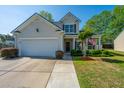 Inviting two-story home with a well-maintained lawn, a two-car garage, and a cozy front porch at 3363 Kinross Ct, Summerville, SC 29485