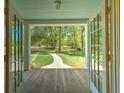 Inviting view of the home's property from the front porch, showing a tree-lined yard at 345 Mentor Rd, Summerville, SC 29483