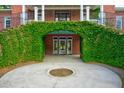 Unique entrance with greenery-covered archway leading to the front door and upper balcony at 349 Mentor Rd, Summerville, SC 29483