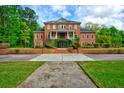 Charming brick home with lush greenery, symmetrical design, and manicured front yard at 349 Mentor Rd, Summerville, SC 29483