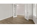 Bright, airy bedroom with wood floors, double doors, and a sunlit window at 503 Fiskdale Cir, Summerville, SC 29486
