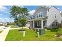 Well-maintained home featuring a two-car garage, manicured lawn, and charming curb appeal at 5138 Preserve Blvd, Ladson, SC 29456