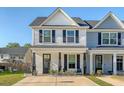 Charming two-story townhome with dark shutters, classic siding, and inviting front porch at 518 Green Fern Dr, Summerville, SC 29483