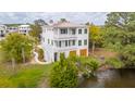 Beautiful marsh front home with metal roof and lush landscaping at 546 Towles Crossing Dr, Johns Island, SC 29455