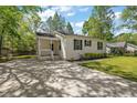 Inviting single-story home with a well-maintained lawn, trees, and long driveway at 63 Guerry Cir, Goose Creek, SC 29445