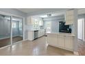 Bright kitchen with white cabinets, black appliances, and a sliding glass door at 63 Guerry Cir, Goose Creek, SC 29445