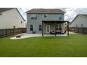 Spacious backyard featuring a pergola-covered patio and artificial grass at 7638 Haywood St, North Charleston, SC 29418