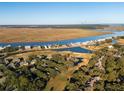 Breathtaking aerial view of the property showcasing its proximity to the waterway and golf course at 764 Summerwind Cir, Edisto Beach, SC 29438