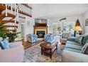 Inviting living room with fireplace, spiral staircase, comfortable seating and view to sunroom at 764 Summerwind Cir, Edisto Beach, SC 29438