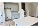 Bright kitchen with gray cabinets, quartz countertops, tile backsplash, and center island at 766 Blueway Ave, Summerville, SC 29486
