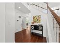 Bright foyer with hardwood floors, a staircase, and stylish decor enhancing the home's welcoming ambiance at 9652 Spencer Woods Rd, Ladson, SC 29456