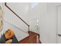 Bright foyer with hardwood floors, a staircase, and large windows adding to the home's welcoming ambiance at 9652 Spencer Woods Rd, Ladson, SC 29456