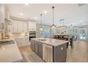 Modern kitchen featuring a center island, stainless steel appliances, and tile backsplash at 1010 Deep Gap Rd, Ridgeville, SC 29472
