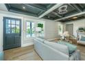 Bright living room with hardwood floors, panelled walls, and a detailed ceiling making it perfect for entertaining at 1011 Ashley Ave, Charleston, SC 29403