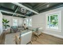 Sunlit living room with modern furnishings, hardwood floors, and custom ceiling details adding a touch of sophistication at 1011 Ashley Ave, Charleston, SC 29403