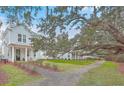 Beautiful homes with manicured lawns and sidewalks lined with large trees, creating a desirable neighborhood at 1032 Avenue Of Oaks, Charleston, SC 29407