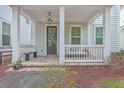 Inviting front porch featuring a cozy bench swing, creating a relaxing and welcoming entrance to the home at 1032 Avenue Of Oaks, Charleston, SC 29407