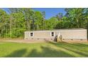 Exterior of home featuring new stairs, tan siding, and green yard at 1086 Arrowhead Rd, Saint Stephen, SC 29479