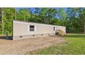 Exterior of home featuring fresh gravel and green yard at 1086 Arrowhead Rd, Saint Stephen, SC 29479