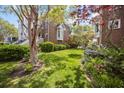 Lush green lawn and vibrant plantings add beauty and charm to the property's exterior at 11 Harleston Pl, Charleston, SC 29401