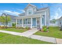 Beautiful two-story home with a welcoming front porch, lush landscaping, and charming curb appeal at 110 Angelica Ave, Summerville, SC 29483