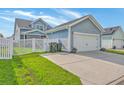 View of the garage with a white door, blue siding, and fenced yard at 110 Angelica Ave, Summerville, SC 29483