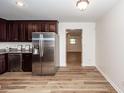 Bright kitchen featuring stainless steel refrigerator and dark cabinets at 115 White Blvd, Summerville, SC 29483