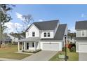 Attractive two-story home with a modern facade, attached garage, and well-kept front yard at 116 Slater Lake Ln, Summerville, SC 29483
