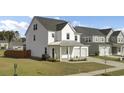Stylish two-story home featuring modern architecture, a well-manicured lawn, and attached garage at 116 Slater Lake Ln, Summerville, SC 29483