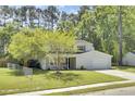 Attractive home featuring a well-kept lawn, mature trees, and an inviting front porch at 116 Trestlewood Dr, Summerville, SC 29486