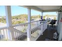 Inviting porch with a view, featuring outdoor seating and stylish decor at 126 Jungle Rd # 7B, Edisto Beach, SC 29438