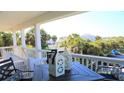 Scenic porch view with outdoor table setting and decorative lanterns at 126 Jungle Rd # 7B, Edisto Beach, SC 29438