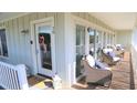 Charming porch with cozy seating, lanterns, and a decorated front door adding to the curb appeal at 126 Jungle Rd # 7B, Edisto Beach, SC 29438