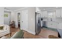 Open-concept kitchen with stainless steel appliances and hardwood floors at 13 H St, Charleston, SC 29403