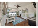 Relaxing screened porch with comfortable seating, ceiling fan, and view to the yard, ideal for enjoying the outdoors at 1339 River Otter Court, Mount Pleasant, SC 29466