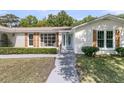 Close-up of the home's entry with a blue door and decorative shutters at 1387 W Lenevar Dr, Charleston, SC 29407