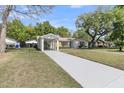 Well-maintained front exterior with covered parking and mature landscaping at 1387 W Lenevar Dr, Charleston, SC 29407