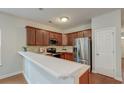 Kitchen with stainless steel appliances, hardwood floors and stone countertops at 1453 Joy Ave, Charleston, SC 29407