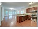 An open kitchen and living room area with hardwood floors at 1453 Joy Ave, Charleston, SC 29407