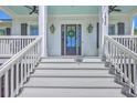 Welcoming front entrance features white stairs, a dark door with wreath, and stylish exterior lighting at 1535 Capel St, Mount Pleasant, SC 29466