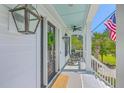 Charming front porch with rocking chairs, elegant lights, and a view of the manicured lawn at 1535 Capel St, Mount Pleasant, SC 29466
