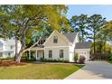 Inviting home boasting a lush lawn, mature shade trees, and an attached two-car garage at 1543 Gemstone Dr, Mount Pleasant, SC 29464